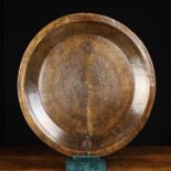 A Large 19th Century Turned Wooden Dish with a flat base (warped) and raised sides,