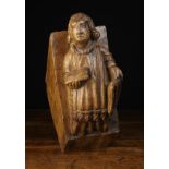 A 16th Century English Oak Corbel/Beam End carved with Saint Lawrence depicted with curly hair