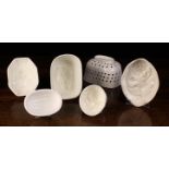 Five Antique White Glazed Ceramic Decorative Culinary Moulds of various designs and a draining dish