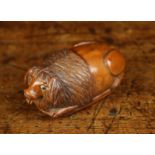 An Early 19th Century Coquilla Nut Snuff Box intricately carved in the form of a recumbent dog with