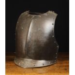 An Early 17th Century One-Piece Blackened Iron Breastplate having a pronounced vertical mid-bone