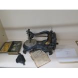 A Victorian Jones sewing machine company hand sewing machine with instructions and a letter from the