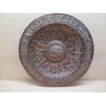 An embossed copper charger dish embellished with Neptune, mermen, and mermaids, 45cm diameter,