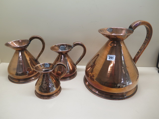 Four copper measuring jugs from 1/2 pint to 1 gallon, multiple dents to 1/2 pint others generally