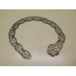 A silver plated cherub belt, 72cm long, in good condition, some usage marks