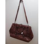 A Sage brown leather holdall with strap, 53cm wide, some usage wear but reasonably good