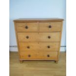 A Victorian stripped pine chest with two short over three long drawers on turned feet, 117cm tall