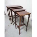 An Edwardian nest of four mahogany crossbanded side tables, 70cm tall x 54cm x 38cm