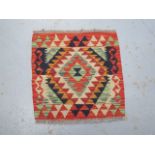 A hand knotted woollen Chobi Kilim rug, 49cm x 50cm