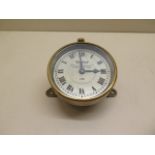 Watford: An early car clock of brass construction with footboard angled mount, the 9cm diameter