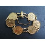 A gold bracelet set with six George V half sovereigns, dated 1914, 1913 x 2, 1912 x 2 and 1926,