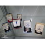 A collection of 7 silver proof boxed coins, total weight approx 110 grams