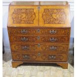 A marquetry inlaid four drawer bureau with a fitted interior, 111cm tall x 97cm x 48cm