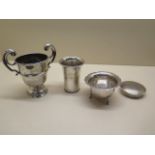 A silver trophy cup, no engraving but some denting, an engraved tumbler, a sugar bowl, and a