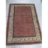 A hand knotted woollen Araak rug, 1.90m x 1.28m