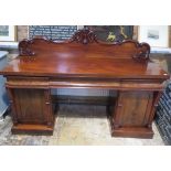 A 19th century twin pedestal sideboard with a carved acanthus scroll upstand, 135cm tall x 188cm x