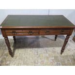 A Victorian writing table / desk with a tooled green leather top with two frieze drawers standing on