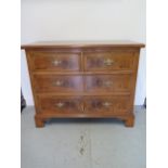 A re-veneered restored early 1900's four drawer chest with star inlay on shaped bracket feet, 96cm
