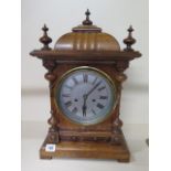 An 8 day oak case striking bracket clock, 50cm tall, with key and running