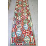 A hand knotted woollen Chobi Kilim runner, 297cm x 84cm