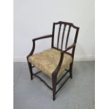 A Sheraton style early 19th century mahogany armchair in polished condition