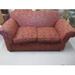 A reupholstered early 1900s drop end two seater sofa, 84cm tall x 163cm x 82cm