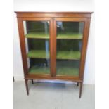 An Edwardian mahogany two door display cabinet with replaced back panel, 130cm tall x 92cm x 35cm