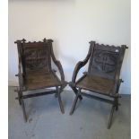 A pair of Victorian oak carved Glastonbury open armchairs, both with some losses to top rail and
