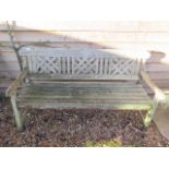 A wooden garden bench, 160cm wide, in weathered condition