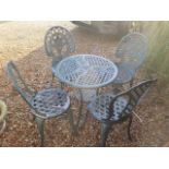 An ornate aluminium garden table and two pairs of chairs, table 60cm diameter