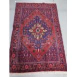 A hand knotted woollen Hamadam rug, 2.00m x 1.20m