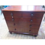 An early Victorian chest of two over three graduated and oak lined drawers with bun handles on
