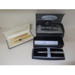 A Parker pen and pencil part set, two plated Parker pens and a boxed Cross ballpoint pen, one plated