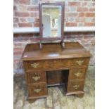 A walnut kneehole desk with five drawers and a cupboard also with a mahogany toilet desk mirror,