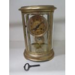 A French oval four glass mantle clock, 27.5cm tall x 19cm wide, striking on a single gong, in good