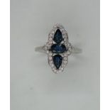 An 18ct white gold marquis shape sapphire and diamond ring, size M, hallmarked, head approx 20mm x