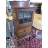 An Edwardian Mahogany cabinet with a glazed door above 4 drawers , 128 cm tall , 52 x 38 cm
