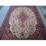 A hand knotted woollen Tabriz rug, 3.35m x 2.44m, in good condition