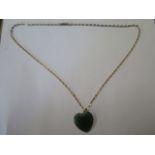 A green jade pendant on a 9ct yellow gold 46cm chain, chain approx 3 grams, generally good