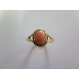 A hallmarked 9ct yellow gold coral ring, size O, approx 2.3 grams, minor abrasions but generally