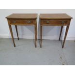A pair of walnut bowfronted wine tables each with a single drawer on square tapering legs, made by a