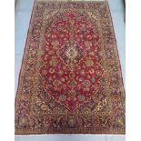 A hand knotted woollen Kashan rug, 2.22m x 1.40m