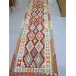 A hand knotted woollen Chobi Kilim Runner, 307cm x 66cm, in good condition