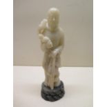 A Chinese hand carved soapstone figure of standing male figure, circa 1930, 24cm tall, minor