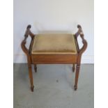 An Edwardian inlaid mahogany music stool with a lift up seat