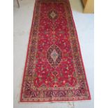 A hand knotted woollen Kashan Runner, 2.80m x 1.04m, in good condition