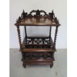 A 19th century rosewood Canterbury with drawer on sugar barley supports and caned panels, 96cm