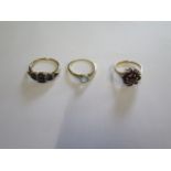 An 18ct yellow gold ring, size M, approx 1.2 grams (worn), a hallmarked 9ct garnet ring, size L