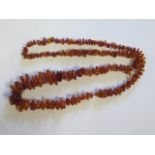 A long amber bead necklace, 74cm long