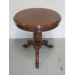 A mahogany circular side table on a carved tripod base, 77cm tall x 69cm diameter